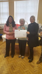 Mariza Jurgens, volunteer fundraiser, Bridie Alexander our lucky winner, Hannah Doody, Director of Social Services Merton, 