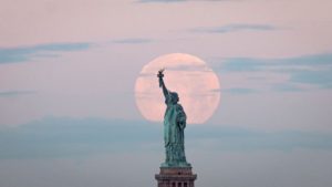 The Super Moon behind the Statue Of Liberty