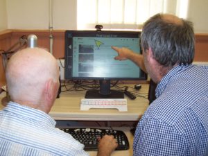 Mark and a service user on a computer, using the accessible software Guide Connect