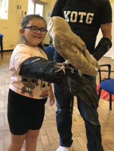 child holding a Barn Owl