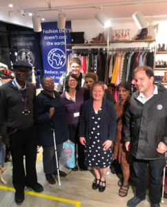A group of people at the Vision Foundation charity shop.